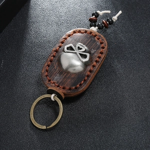 Makro-Detail von Vintage Leder und Holz Schlüsselanhänger mit Totenkopf und Handnaht-Effekt