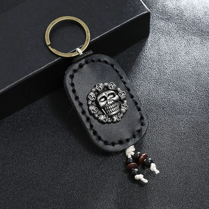 Retro leather keychain with skull relief, handmade stitching and metal ring