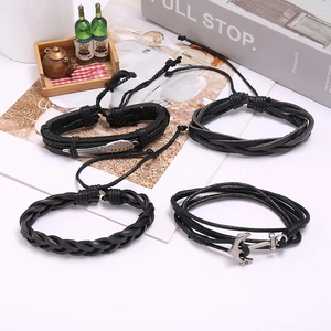 Retro multi-layer black leather bracelet set featuring wing and anchor metal charms