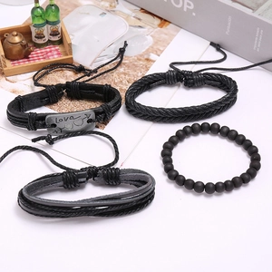Detail of 4-piece set featuring black leather braided bracelets with Love engraving
