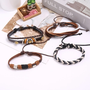 Set of four vintage braided leather bracelets with wooden beads and metal charms
