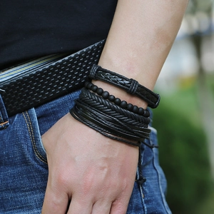 Men's multi-layer black braided leather bracelet set with matte beads on model's wrist