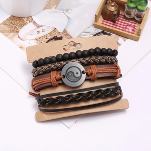 Detail showing multilayer braided leather bracelets with Yin Yang metal charm on display card