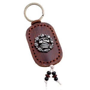 Retro handmade leather skull keychain with bronze metal finish and bead tassels