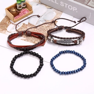 Detail of 4-piece vintage leather bracelet set with woven feather charm and beads