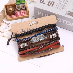 Vintage braided leather bracelet set for men with silver feather charms on display card