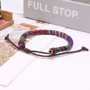 Bohemian colorful woven bracelet with adjustable brown cord in a stylish setup