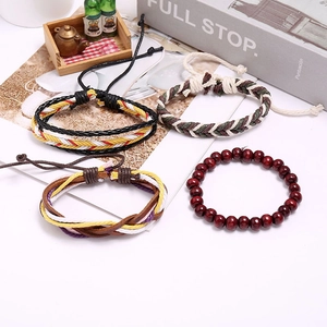 Detail view of ethnic style braided leather bracelet set with wooden beads and cords