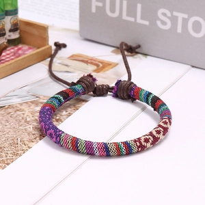 Close-up of bohemian woven bracelet featuring colorful geometric patterns and adjustable cord