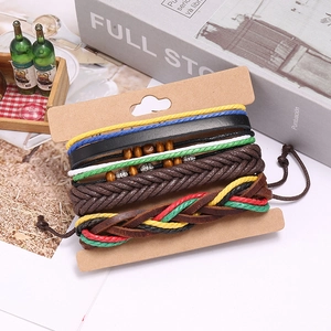 Detail of woven leather bracelets featuring wooden beads and retro metal charms