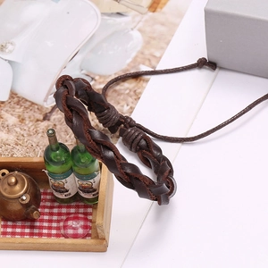 Retro dark brown braided leather bracelet with adjustable sliding knot on a creative display