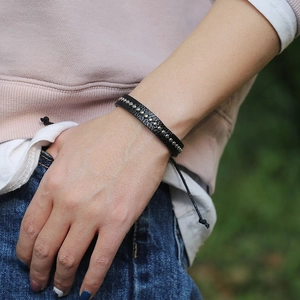 Handmade black leather punk bracelet with silver metal rivets and adjustable cord