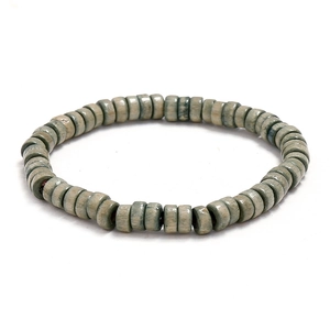 Minimalistische groene houten kralenarmband met natuurlijke texturen op witte achtergrond