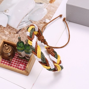 Multicolor braided leather bracelet with adjustable cord on decorative wooden tray