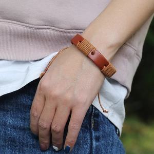 Retro brown braided leather bracelet with yellow thread wrap for a vintage punk style look