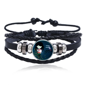 Macro shot of Aquarius zodiac multilayer leather bracelet with a luminous glass charm