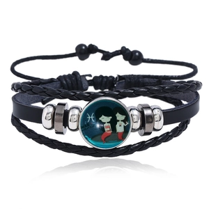 Detailed close-up of woven leather bracelet featuring Pisces zodiac sign and silver metal beads