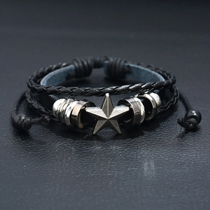 Vintage black braided leather bracelet featuring a silver star pendant and adjustable cord