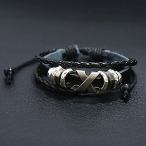 Handmade woven black leather bracelet with bronze X charm and polished silver beads