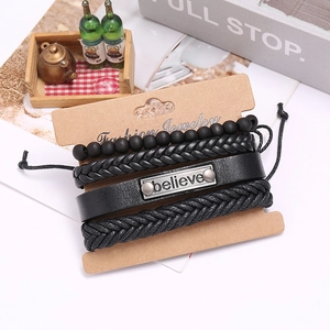 Macro detail of men's vintage black leather bracelet set with believe metal plate