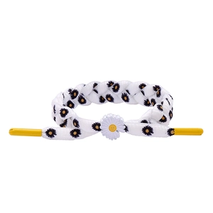 Braided daisy bracelet with white woven fabric and yellow accents for a minimalist look
