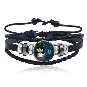 Detail of multi-layer black leather Taurus zodiac bracelet with luminous glass gem