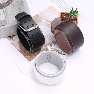 Set of wide vintage leather bracelets in black, brown and white with metallic buckles