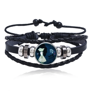 Macro detail of Virgo zodiac leather bracelet featuring luminous glass cabochon and woven bands