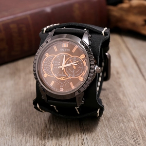 Detail view of a vintage men's leather cuff watch with bold stitching and bronze dial