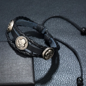 Black multilayer leather punk bracelet with bronze skull charms and braided rope