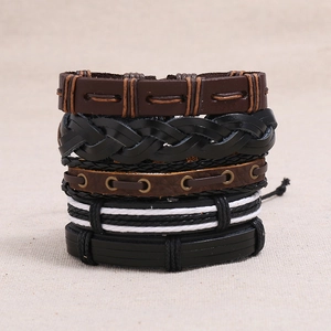 Detail of vintage braided leather bracelets set in black and brown with woven ropes