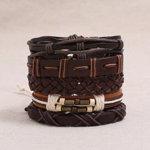 Detail of multi-layer leather bracelets with woven ropes, beads, and metal accents