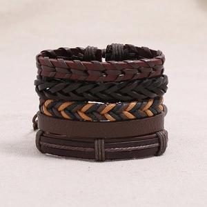 Macro detail of multi-layer vintage braided leather bracelets with mixed textures
