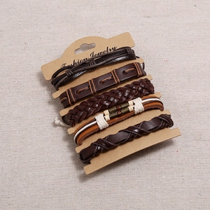 Five-piece vintage multilayer woven leather bracelet set for men on cardboard