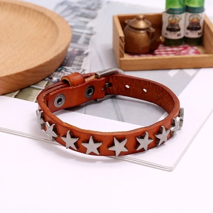 Close-up of brown leather punk bracelet with silver star rivets and adjustable buckle