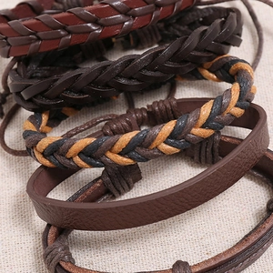 Close-up of vintage multi-layer braided leather bracelets in dark brown and black tones
