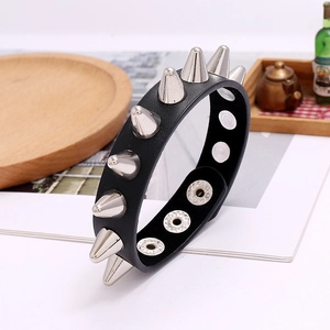 Detail view of the punk leather bracelet showing metallic spikes and snap button closures