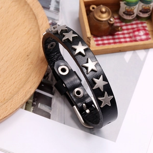 Detail of black leather punk bracelet with six silver metal stars and snap button