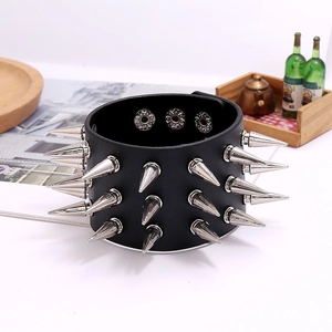 Punk style wide black leather bracelet with three rows of silver metal spikes and snaps