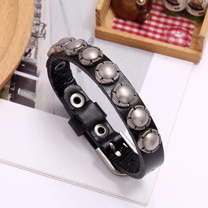 Detail of punk style black leather bracelet with silver metal studs and adjustable buckle