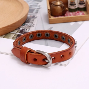 Close-up of vintage brown leather star bracelet with silver buckle and rustic textures