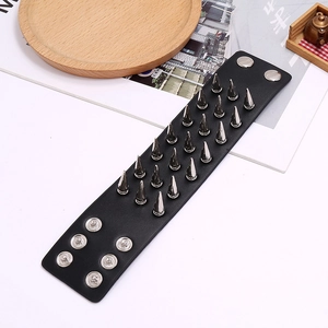 Detail of wide black punk leather bracelet with three rows of silver metal cone spikes