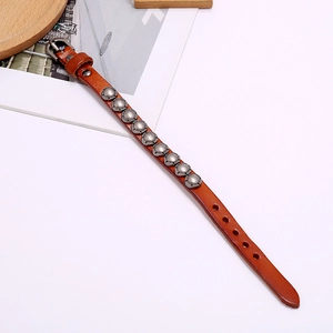 Detail of vintage punk leather bracelet with silver studs and adjustable metal buckle