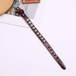 Detailed view of brown leather punk bracelet with silver star rivets and buckle