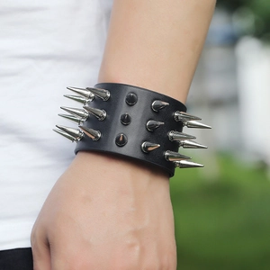 Close-up of triple-row silver cone studs on a wide black leather punk rock bracelet