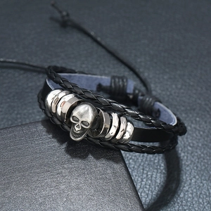 Punk style multilayer black leather bracelet featuring a silver skull and metal rings