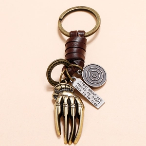 Vintage bronze skeleton hand keychain with leather braided strap and engraved tag