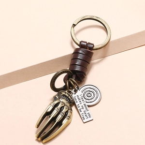 Vintage braided leather keychain with bronze skull claw pendant and engraved metal tags