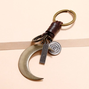 Handmade vintage crescent moon keychain with brown leather wrap and bronze pendant