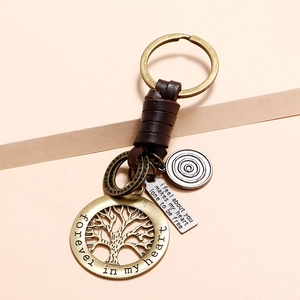 Handmade bronze tree of life keychain with brown leather wrap and engraved pendant charms